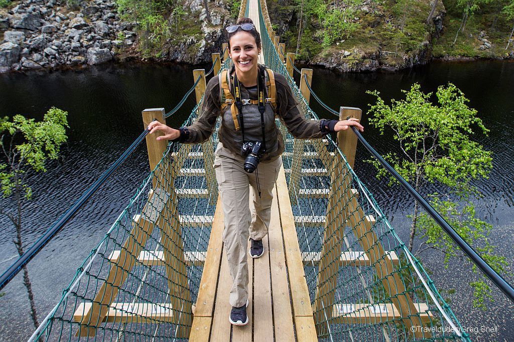 Young girl walking on Julma-Ölkky suspension bridge.
